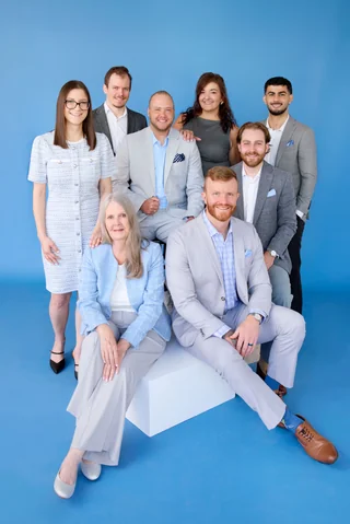 The Noulty Financial team on a blue backdrop
