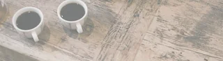 two coffee cups on weathered kitchen table